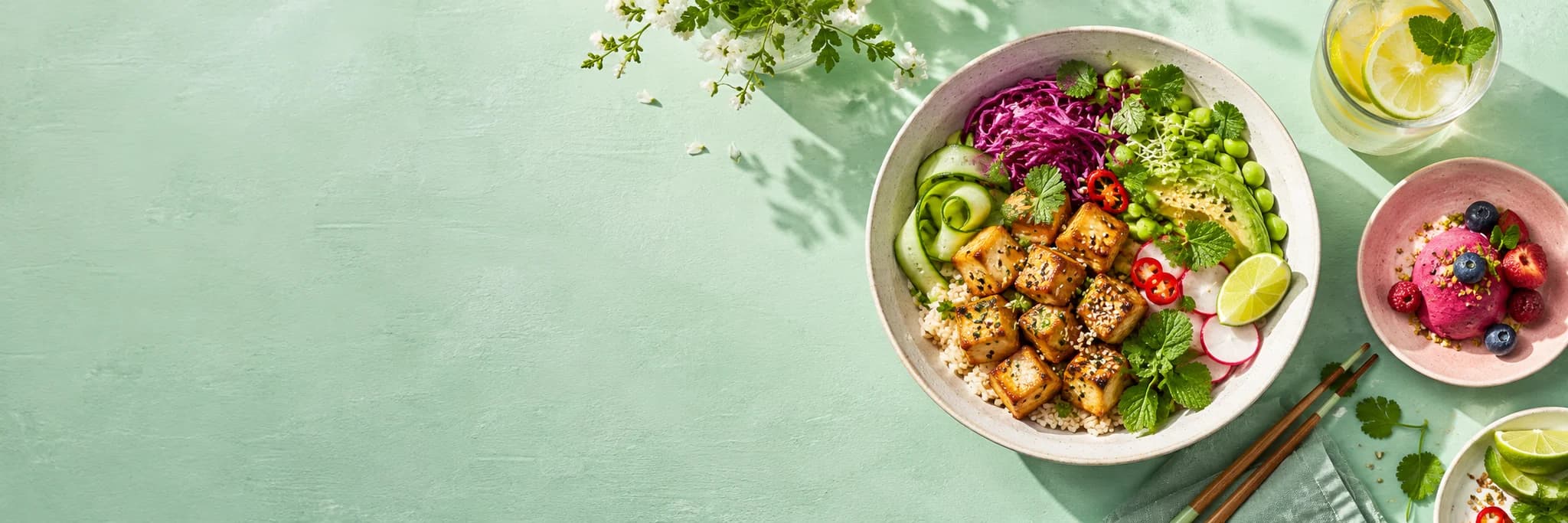 AI-created editorial image of a colourful tofu bowl, berry dessert and citrus drink; not a restaurant photograph.